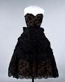 Image of Woman's black lace evening gown, over pink-orange taffeta, 1957